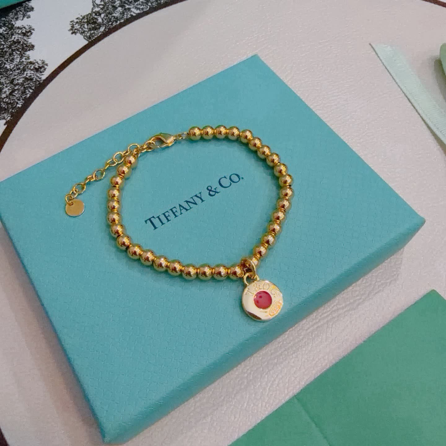 Tiffany & Co. Gold Bead Bracelet with Red Enamel Charm